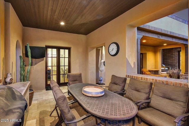 dining room with recessed lighting, french doors, wood ceiling, and stone tile floors