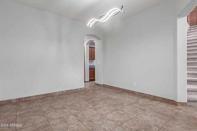 unfurnished room with light tile patterned floors