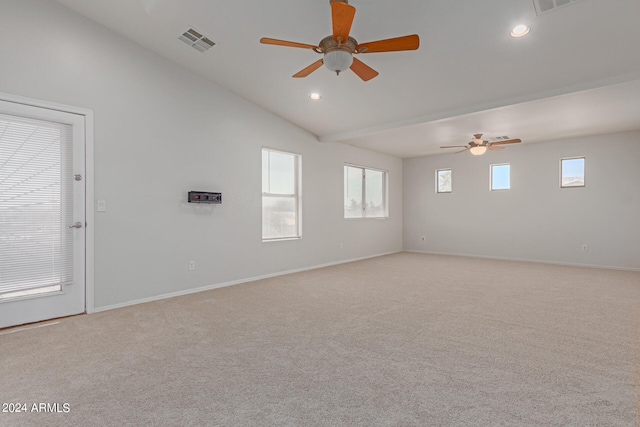 carpeted spare room with ceiling fan, a wealth of natural light, and lofted ceiling