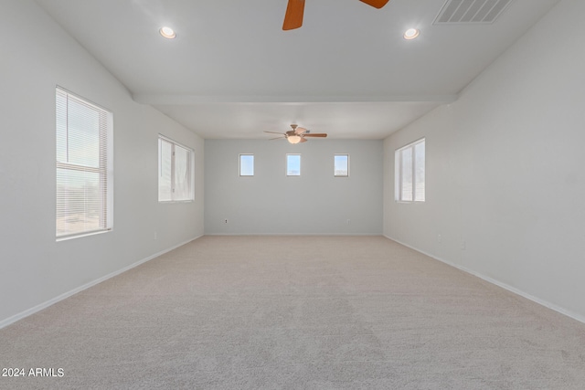 carpeted spare room with ceiling fan