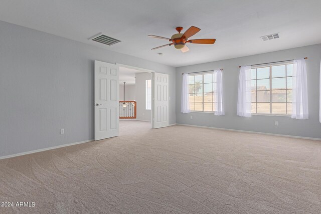 interior space featuring light colored carpet and ceiling fan