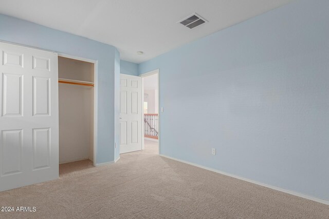 unfurnished bedroom featuring a closet and carpet