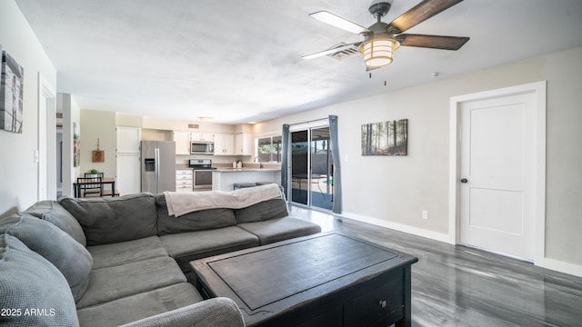 2139 W Obispo Ave, Mesa, AZ 85202 - living area with baseboards, a ceiling fan, and dark wood finished floors