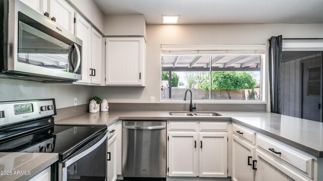2139 W Obispo Ave, Mesa, AZ 85202 - kitchen with stainless steel appliances, a sink, white cabinets, and light countertops