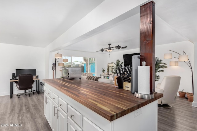 kitchen with light hardwood / wood-style floors, white cabinetry, ceiling fan, and butcher block countertops