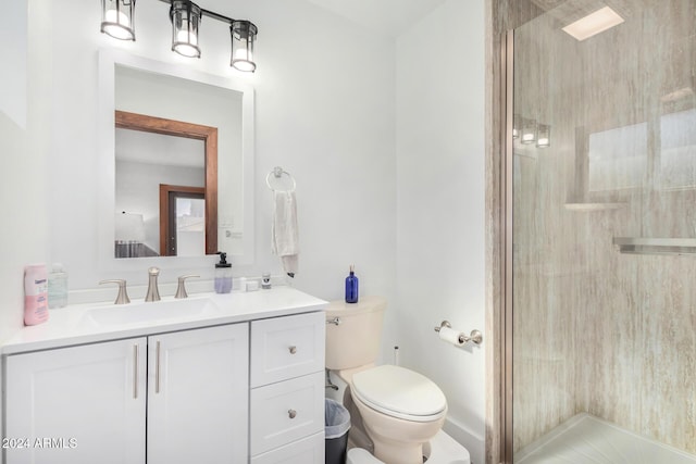 bathroom featuring tile patterned flooring, vanity, toilet, and a shower with door