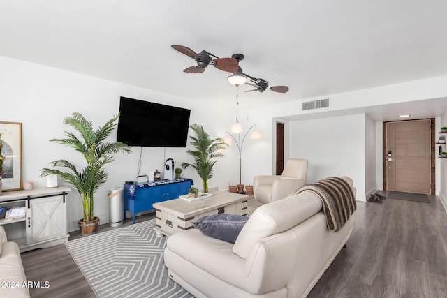 living room featuring ceiling fan and dark hardwood / wood-style flooring