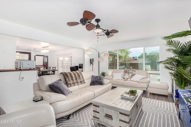 living room featuring hardwood / wood-style flooring and ceiling fan