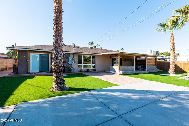 view of front of property with a patio area and a front lawn