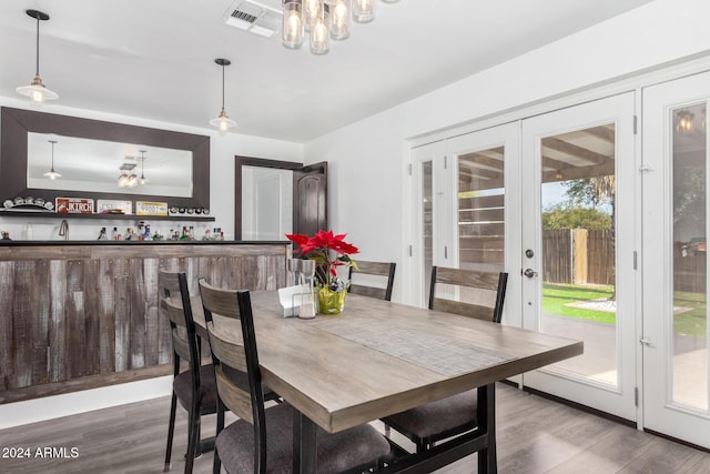 dining area with hardwood / wood-style floors and french doors