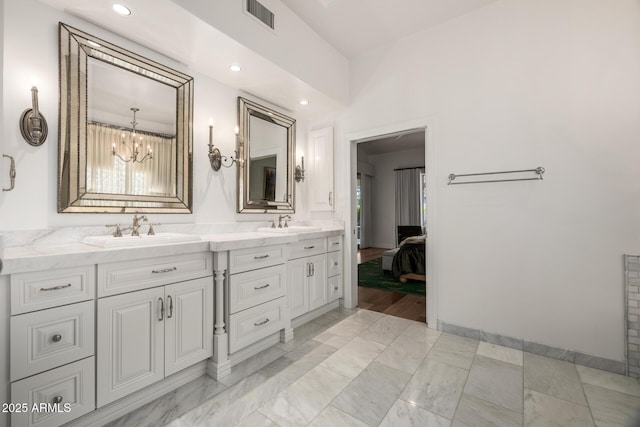 bathroom featuring vanity and a chandelier