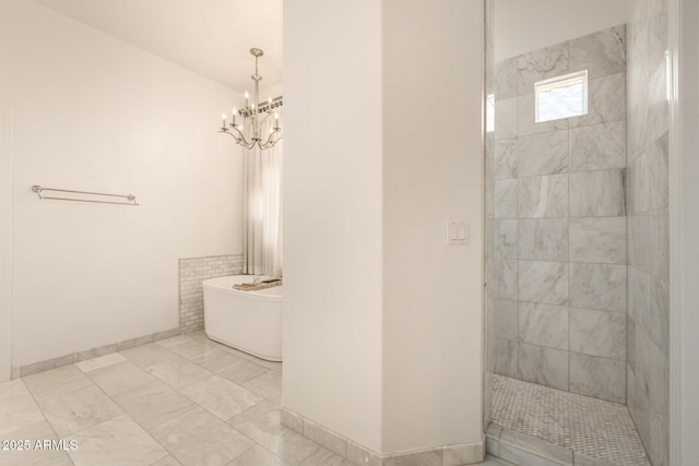 bathroom featuring a notable chandelier and independent shower and bath