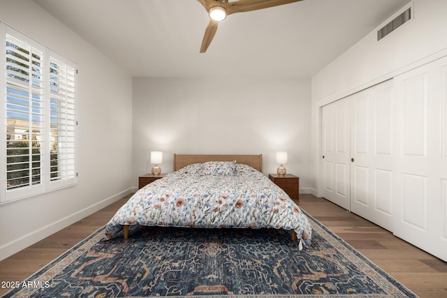 bedroom with ceiling fan, wood-type flooring, and a closet