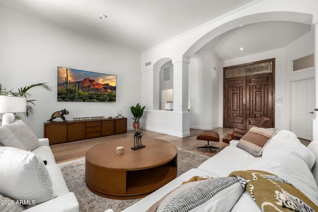 living room featuring ornamental molding and hardwood / wood-style floors