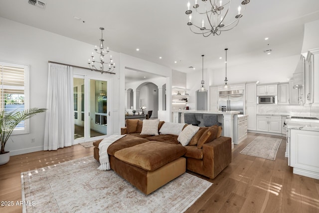 living room featuring light hardwood / wood-style floors and a notable chandelier