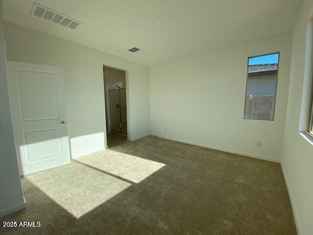 unfurnished bedroom with visible vents, baseboards, and carpet