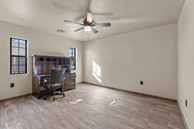 office area with ceiling fan, a wealth of natural light, and light hardwood / wood-style flooring