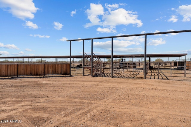 view of yard with a rural view and an outbuilding