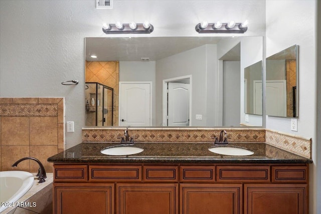 bathroom with a shower stall, a bath, visible vents, and a sink