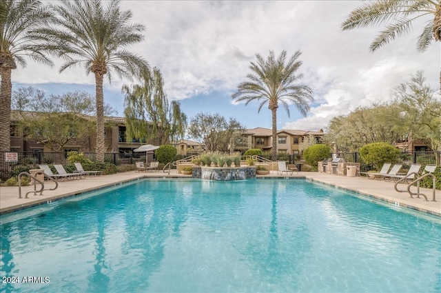 community pool featuring a patio area and fence