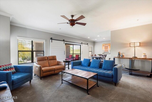 carpeted living room featuring ornamental molding, ceiling fan, and a stone fireplace