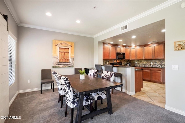 dining area featuring visible vents, light colored carpet, ornamental molding, and light tile patterned flooring