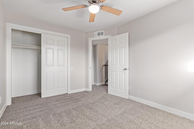 unfurnished bedroom with a closet, ceiling fan, and carpet flooring