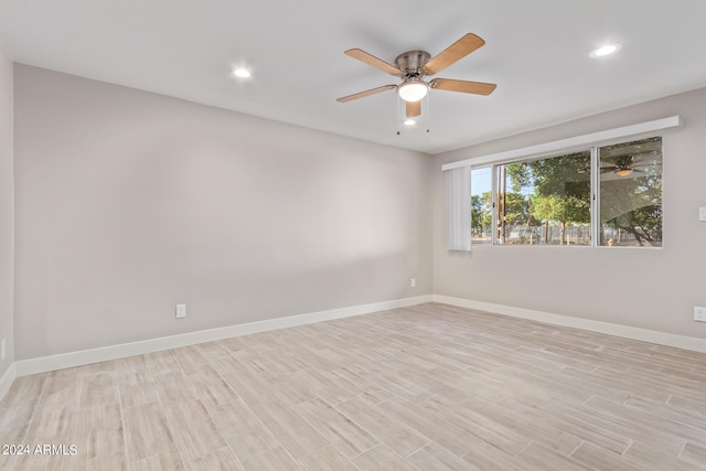 spare room featuring light hardwood / wood-style flooring and ceiling fan