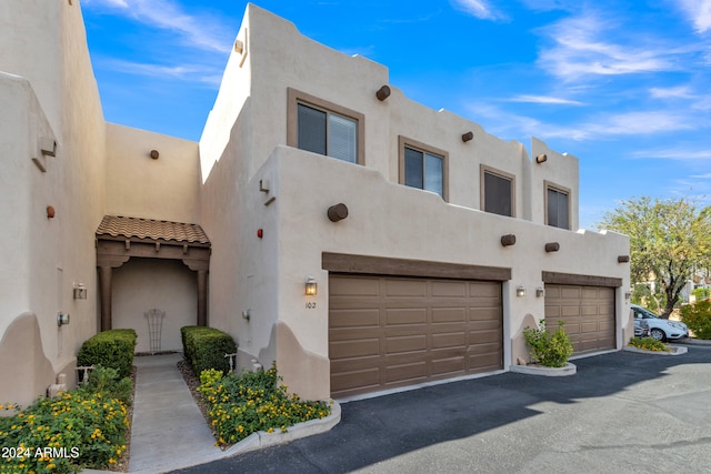 southwest-style home with a garage