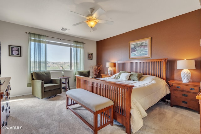 bedroom with ceiling fan and light carpet