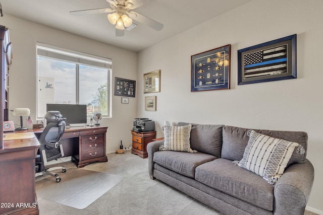 carpeted office space featuring ceiling fan