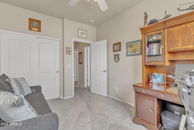 carpeted office space featuring ceiling fan