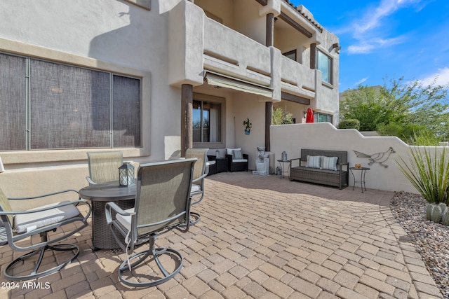 view of patio featuring a balcony and an outdoor hangout area