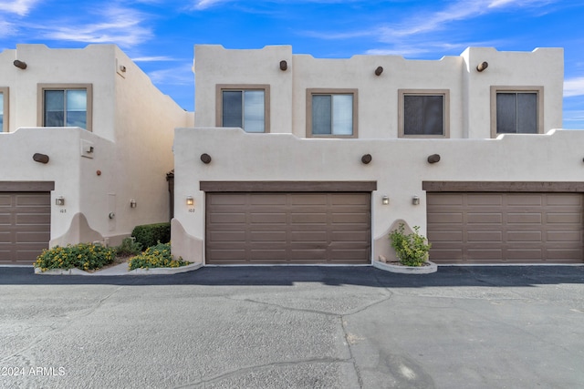 pueblo-style house with a garage