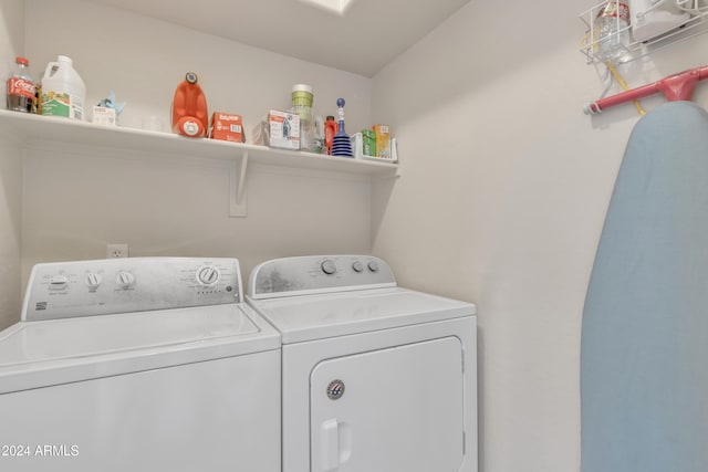 clothes washing area with separate washer and dryer