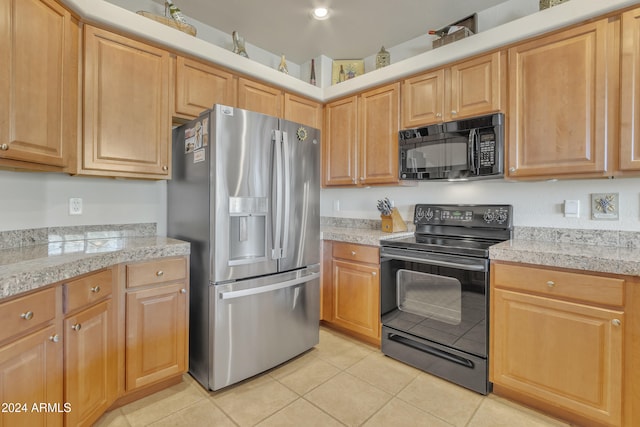 kitchen featuring black appliances and light tile patterned floors