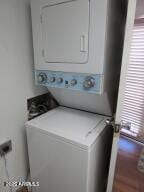 laundry room with stacked washer and clothes dryer