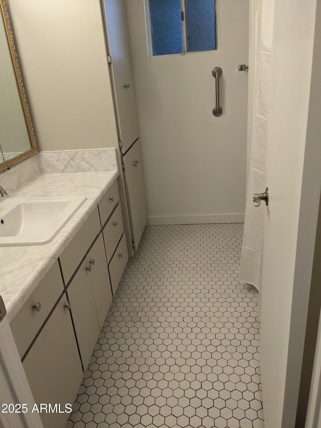 bathroom featuring tile patterned flooring and vanity