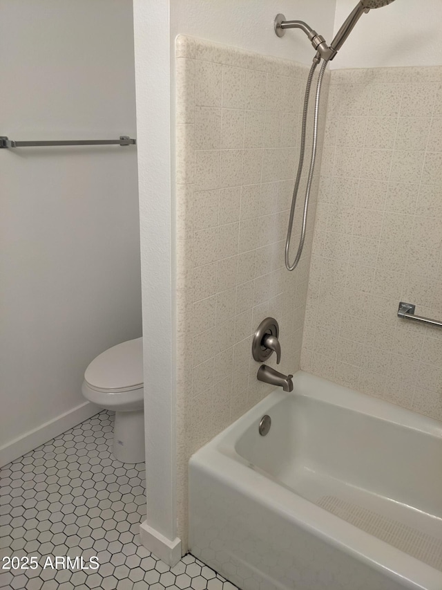 bathroom featuring  shower combination, toilet, and tile patterned flooring