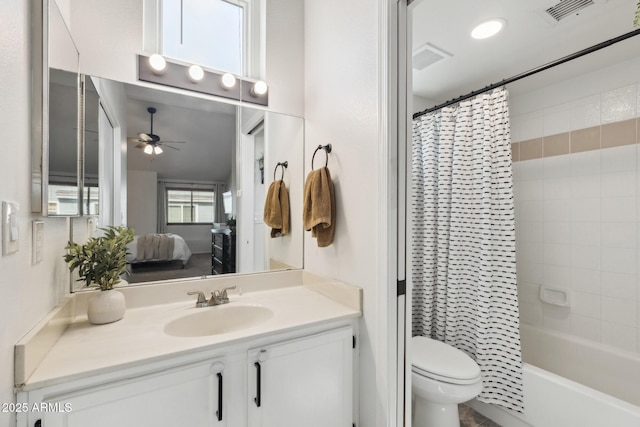 ensuite bathroom featuring a ceiling fan, toilet, vanity, and shower / bathtub combination with curtain