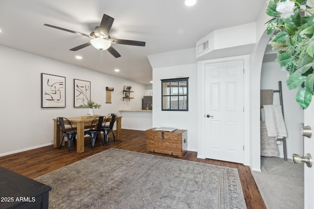 dining room featuring a ceiling fan, wood finished floors, recessed lighting, baseboards, and arched walkways