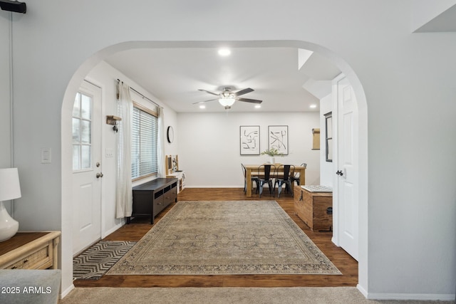 foyer featuring arched walkways, recessed lighting, wood finished floors, ceiling fan, and baseboards