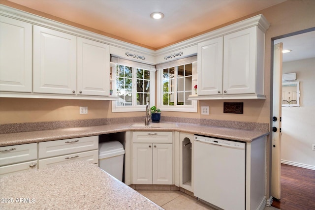 kitchen with dishwasher, a sink, white cabinetry, light countertops, and recessed lighting