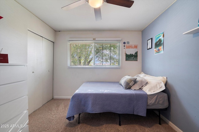 carpeted bedroom featuring a closet, a ceiling fan, and baseboards