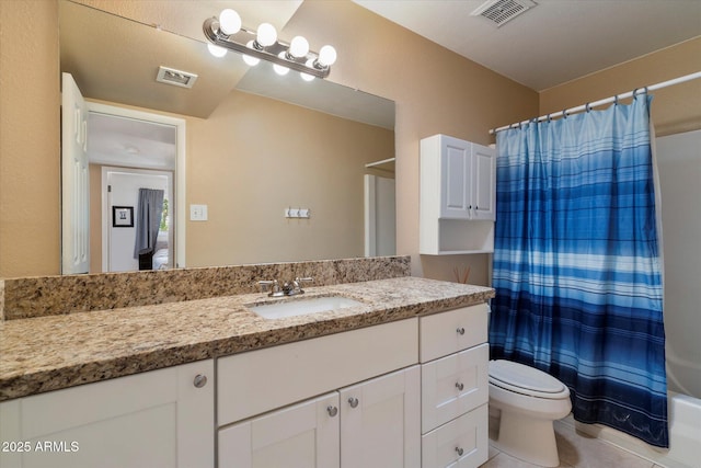 bathroom featuring toilet, vanity, shower / bath combo, and tile patterned floors