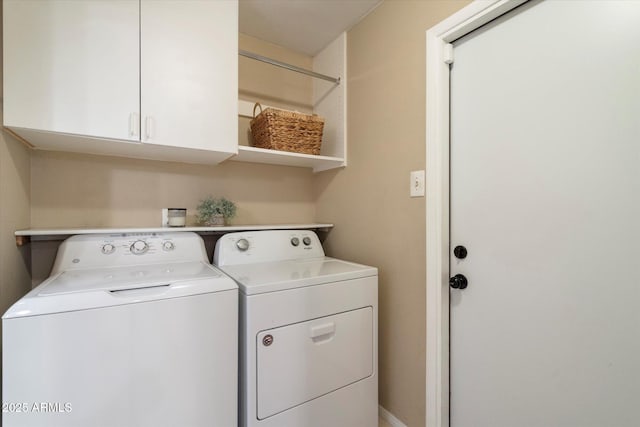 laundry room with washer and clothes dryer and cabinet space