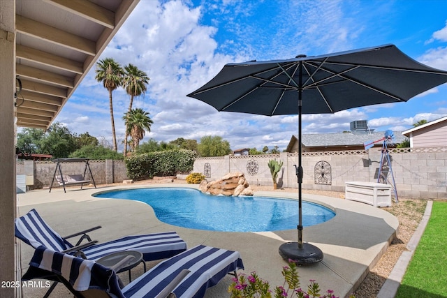 view of swimming pool featuring a patio area and a fenced backyard