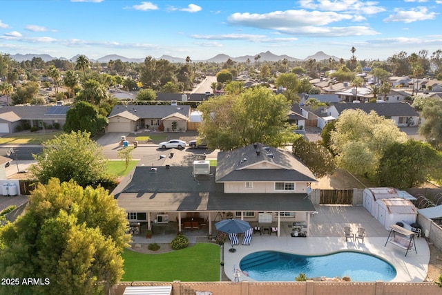 aerial perspective of suburban area with a pool area and mountains