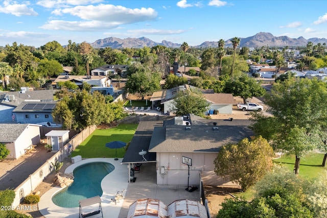 aerial view of residential area featuring a pool area and a mountain backdrop
