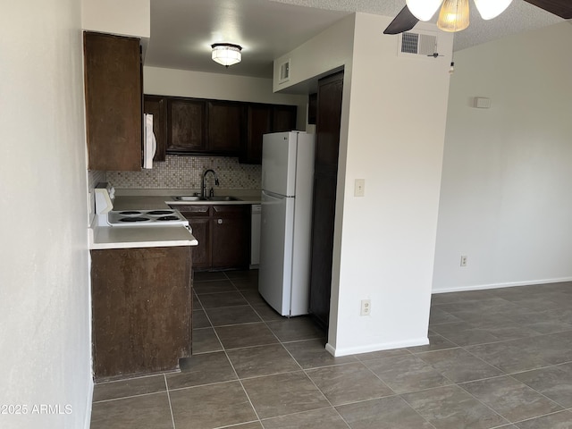 kitchen featuring tasteful backsplash, sink, dark brown cabinetry, tile patterned floors, and white appliances